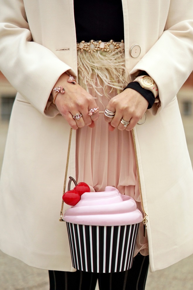 Winnipeg Style Fashion, Loly in the Sky Noela eye lash flats, Kate Spade New York cupcake clutch bag, Anthropologie pink ostrich feather belt, Le chateau beige classic coat, BCBG Jaylin pleated pink skirt